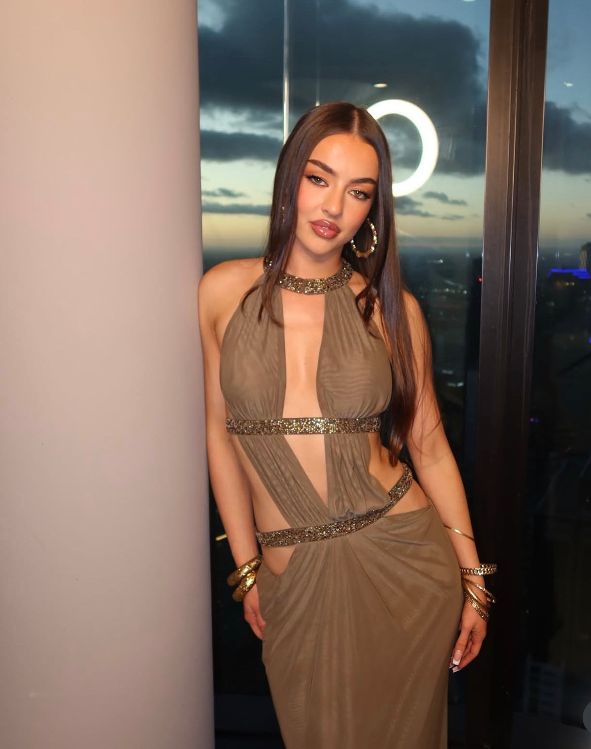 Khaki cut-out backless maxi dress in double layer mesh with hotfix crystals diamante straps and caged back detail. Fastens at hip, bust and front of neck with hook & eyes